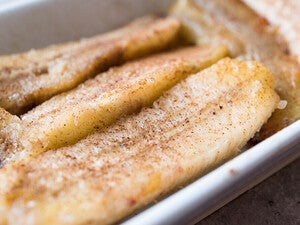 Caramelized banana slices in a white dish.