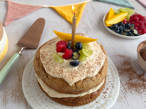 Photograph: tall pancake stack with butter, syrup pouring and mixed berries
