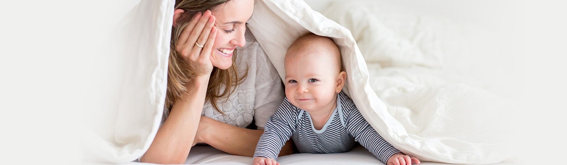 Mãe e bebé debaixo dos lençóis