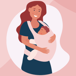 Smiling mother with long auburn hair cradling a sleeping baby wrapped in pink blanket